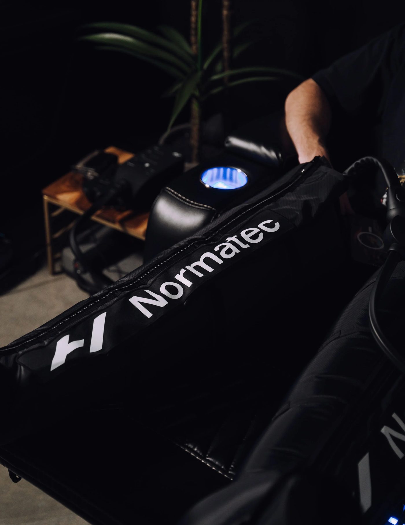 Normatec compression therapy boots on a recliner at Revive Wellness Place